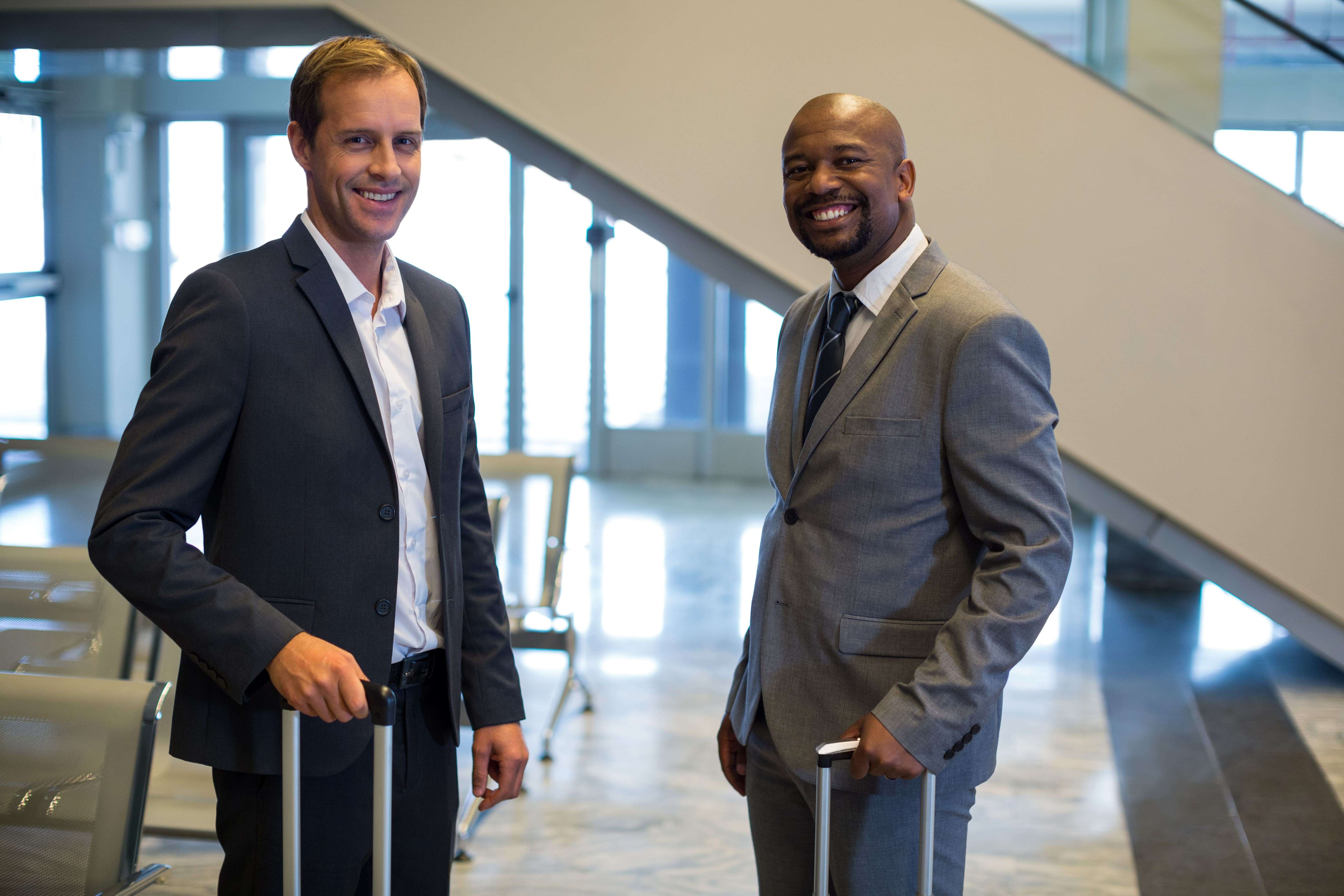 business-people-standing-with-luggage-bag-airport-min(1)