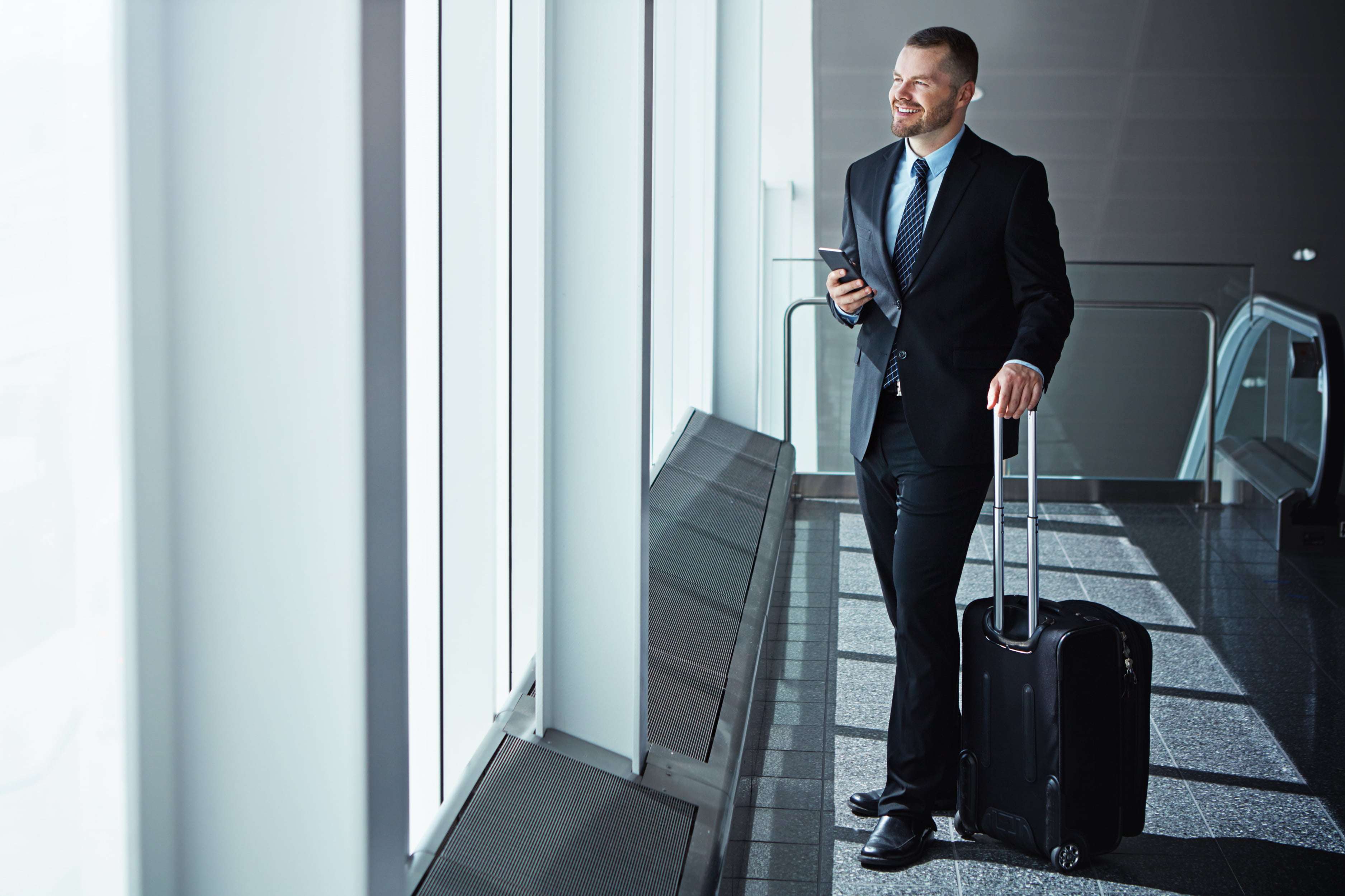 ideas-thinking-businessman-airport-with-phone-luggage-suitcase-travel-booking-vision-entrepreneur-corporate-worker-texting-social-media-mobile-app-international-flight-min